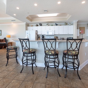 Sip your morning coffee at the breakfast bar and get ready for a beach day in this stylish space