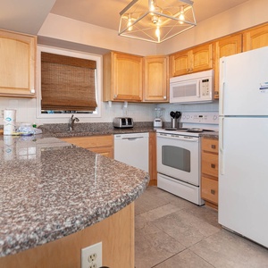 This kitchen features a sleek design, modern appliances, and a bright atmosphere, perfect for meal preparation