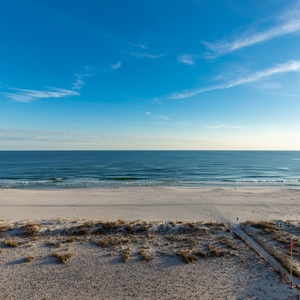 This inviting view showcases a serene beachfront, perfect for relaxation and enjoying the tranquil waters