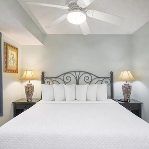 The king suite features a plush bed and soft lighting, creating a serene retreat for restful nights