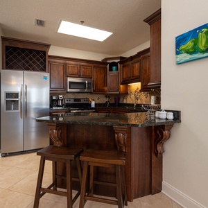 The stylish cabinetry complements the stainless appliances and granite countertops in this kitchen