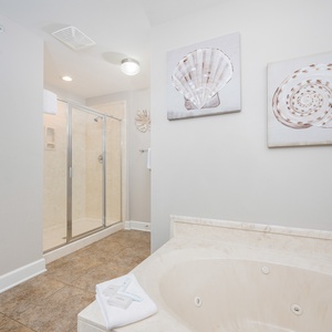Master bathroom featuring a jetted tub, walk-in shower, and coastal-inspired decor for a refreshing retreat