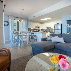 Unwind in the spacious living area with a comfortable sofa, stylish decor, and a dining space bathed in natural light