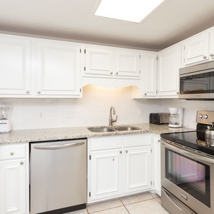 Stainless appliances and granite countertops in this inviting kitchen, featuring a blender and coffee maker