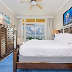 Retreat to the king master suite with cozy bedding and drift off to the sound of the waves from the balcony