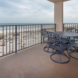 Dine al fresco at the outdoor table with comfortable seating, enjoying gentle breezes and views of the beach