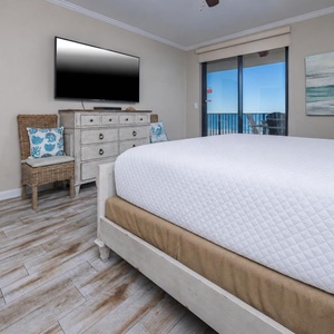 Relax in this inviting master bedroom with a king bed, stylish decor, and direct access to beautiful views outside
