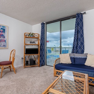 This living area features a cozy seating arrangement with a lagoon view, perfect for relaxation and enjoying the scenery