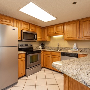 Prepare meals in the spacious kitchen, featuring granite countertops and stainless appliances