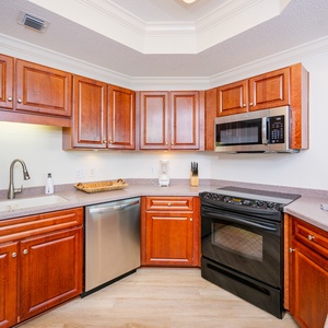 Craft delicious meals surrounded by warm wood cabinetry and ample counter space, enhancing your culinary experience