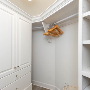 Store your belongings in this spacious master closet with ample shelving and hanging space for your convenience