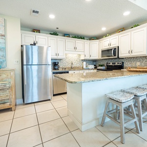 Enjoy preparing meals in this stylish kitchen with granite countertops and seating at the breakfast bar