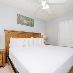 Relax in this comfortable guest bedroom featuring a king bed, stylish decor, and natural light from the window