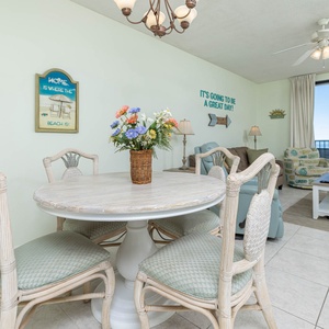 Enjoy meals at the round dining table, surrounded by charming decor and views of the inviting living area