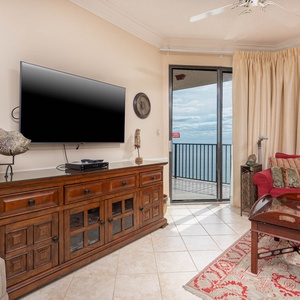 Relax in this inviting living area with a large TV, plush seating, and a view that invites you to unwind