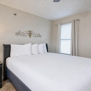 Rest in a soft queen bed, surrounded by calming decor, for peaceful nights after beachside adventures