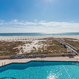 Enjoy the inviting pool area with lounge chairs, perfect for soaking up the sun and taking in the beautiful views
