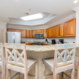 Wake up with morning coffee at the breakfast bar and get ready for a beach day in this stylish space
