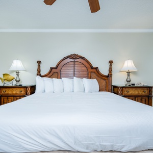 Experience restful nights in this spacious master bedroom featuring a king bed, elegant decor, and charming accents