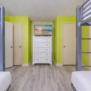 Cozy up in this cheerful bunk room, where laughter and fun await during family movie nights