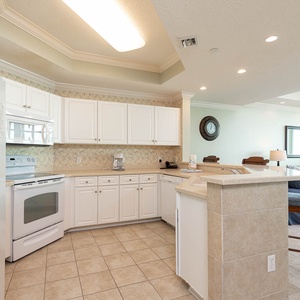 Create memorable family meals in this bright kitchen, featuring ample counter space and white appliances