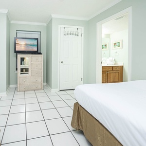 Inviting guest room featuring two beds, a TV, and easy access to the bathroom with fresh towels