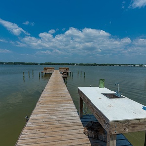 Find your favorite fishing spot on the lagoon dock and clean the dinner catch at Summer House West's cleaning station