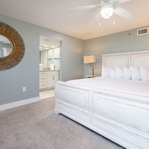 Unwind in the serene master suite featuring a king bed, stylish decor, and easy access to the master bath