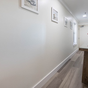 Step into the welcoming hallway adorned with coastal artwork and a stylish console table