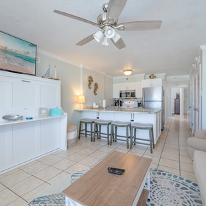 Living area featuring cozy seating, queen sofa-sleeper, and charming coastal decor for a relaxing getaway