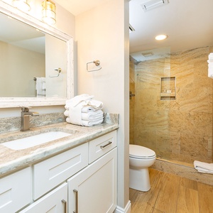 Refresh and rejuvenate in the walk-in shower in the master bath, surrounded by elegant tile and soft towels