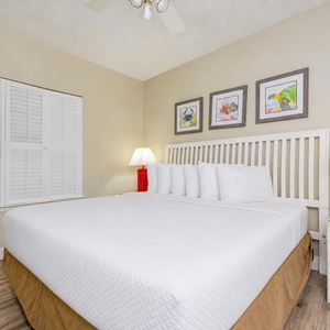 Drift into sweet dreams in this king guest suite, surrounded by cheerful art that enhances the cozy beach vibe