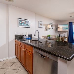 This kitchen features rich wood cabinetry, sleek stainless appliances, and a cozy breakfast bar perfect for morning coffee