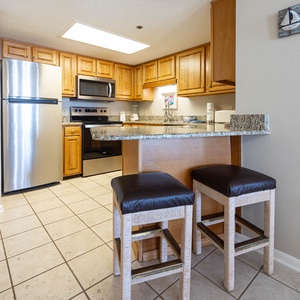Prepare meals in this kitchen, featuring stainless appliances and granite countertops