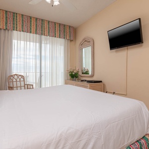 Relax in this inviting master suite with a king bed, a TV, and access to stunning views from the balcony