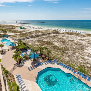 Inviting pool area surrounded by lounge chairs, with easy access to the beach and vibrant outdoor activities