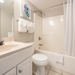 Refresh in the bathroom featuring a vanity, tub-shower, and soft towels for your convenience