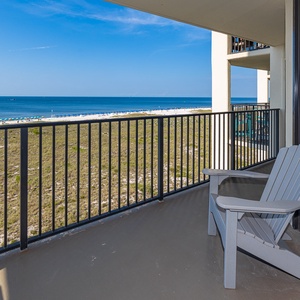 Your balcony invites peaceful moments while you hear distant chatter and watch colorful umbrellas line the shore