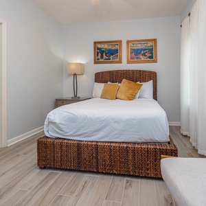 Retreat to this cozy guest bedroom featuring a queen bed, stylish decor, and soft natural light