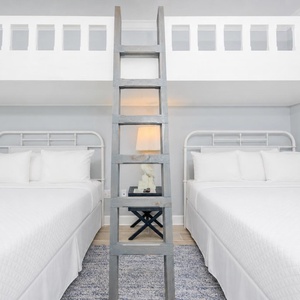 Experience comfort in this charming room with two queen beds below and a cozy loft area with two twin beds