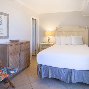 This guest bedroom features a comfortable bed, stylish decor, and a cozy seating area, perfect for relaxation