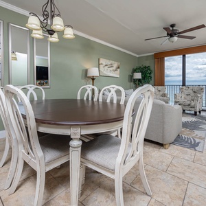 Gather around the elegant dining table, with comfortable seating and views of the beach just beyond the windows