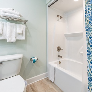Freshen up in this guest bath in the relaxing shower or soothing tub before an exciting beach day