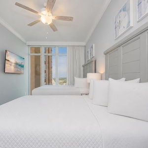 Sleep soundly in soft queen bedding, enjoying coastal views and moments of relaxation in this inviting guest room