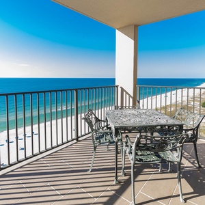 Relax at the outdoor dining table while enjoying sweeping views of the water and coastline from the top floor