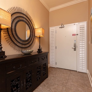 This welcoming entryway features stylish lamps, a decorative mirror, and a sleek console, setting a warm tone for your stay