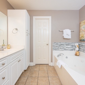 Indulge in relaxation in the master bath with a refreshing walk-in shower and soothing jetted tub