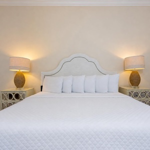 Drift into restful slumber on the soft king bed, surrounded by warm lighting and inviting decor for ultimate relaxation