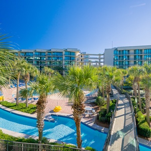 Embrace relaxation by the sparkling pool, surrounded by swaying palms and the serene views of the bay