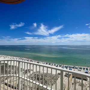 Watch boats glide across the gulf and beach umbrellas dot the shoreline from your balcony